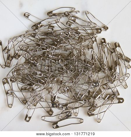 Steel quilting safety pins artistically arranged for a photo shoot.