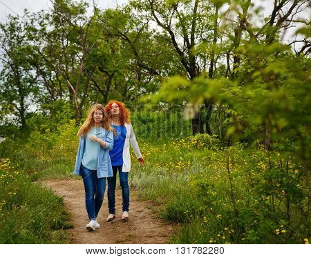 Best friends forever. Girlfriends walking in the park. BFF. Close friends. Gentle friendship.
