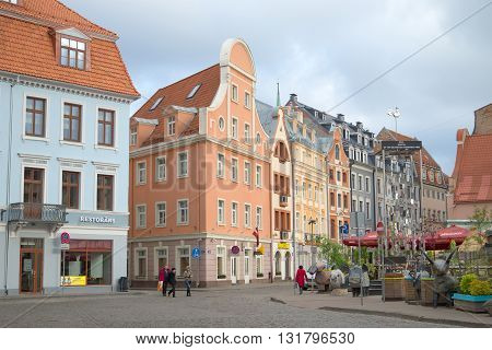 RIGA, LATVIA - MAY 02, 2014: An overcast day in May in the old Riga. People walk on a tourist part of Riga