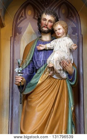 STITAR, CROATIA - AUGUST 27: St. Joseph holding baby Jesus, altar of St. Anthony the Great in the church of Saint Matthew in Stitar, Croatia on August 27, 2015
