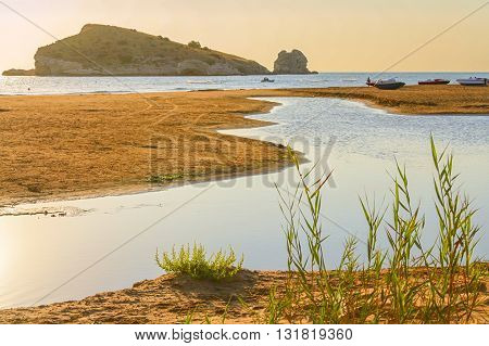 Summertime. Gargano coast: Portonuovo beach,Vieste-(Apulia) ITALY-In the background the Gattarella island.