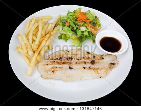Fish fillet with french fries and salad isolated on the black background with clipping path