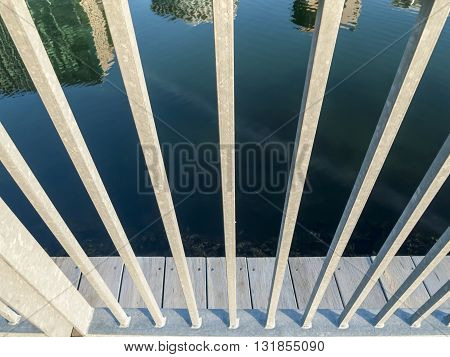 Reflection of Boston waterfront skyline through railing