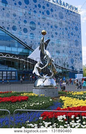 MOSCOW, RUSSIA - MAY 7, 2016: Monument to the dolphins playing with a ball near a building of Moskvarium - Moscow oceanarium with marine animals