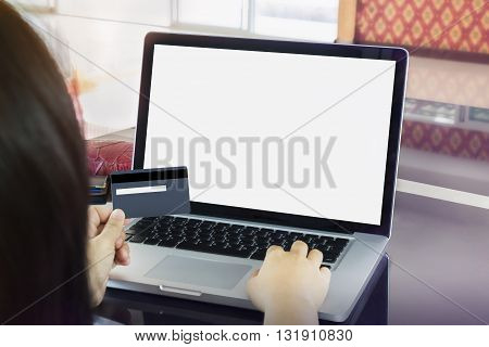 Girl (women) Hand Hold Credit Or Debit Card With Blank Screen Laptop In Home Office, Online Shopping