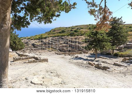 The ruins of the ancient acropolis on a background of a sea landscape on the island of Rhodes in Greece.