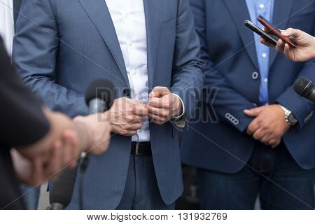 Journalists making interview with businessperson, politician or spokesman. Press conference.