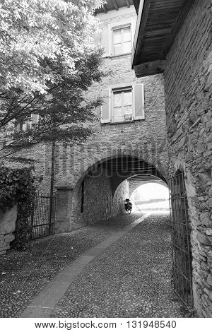 Montevecchia (Lecco Brianza Lombardy Italy): historic village a typical alley. Black and white