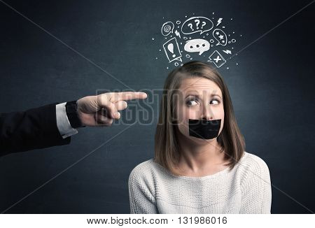 Caucasian business hand pointing at stressed female employee with drawn question, explamation marks above her head