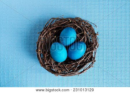 Easter Eggs In The Nest On Blue Background