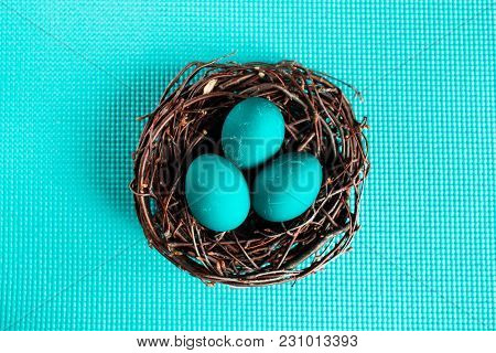 Easter Eggs In The Nest On Blue Background
