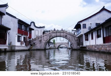 July 5, 2015.  Shanghai, China.  Chinese Tourists On The Many Bridges Over The Water Canals Of Zhaoj