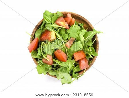 Fresh Arugula And Tomato Salad On Wooden Plate