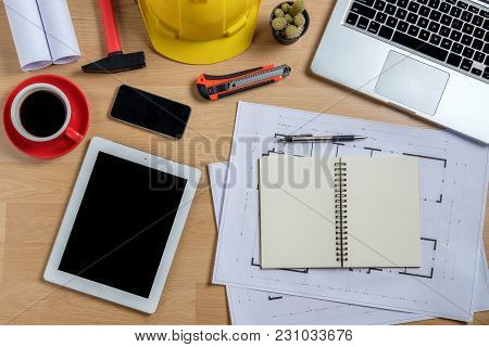 Architectural Office Desk With Laptop,smart Phone,tablet,cup Of Coffee And Engineer Equipment.top Vi