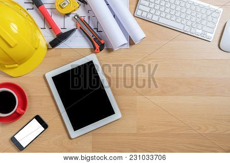 Office Desk With Laptop,smart Phone,tablet,cup Of Coffee And Engineer Equipment.top View With Copy S