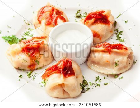 Boiled Dumplings With Sauce On Whilte Plate