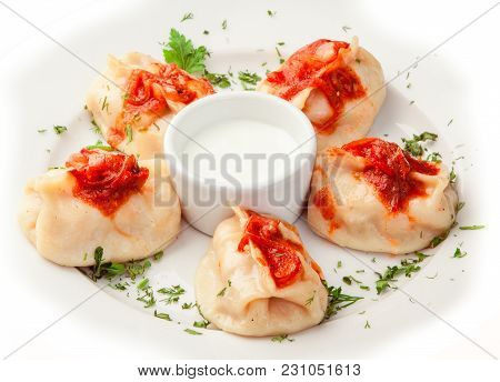 Boiled Dumplings With Sauce On Whilte Plate