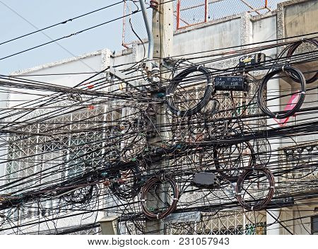 Disarrangement Of Electric Wire On Pole Near Building.