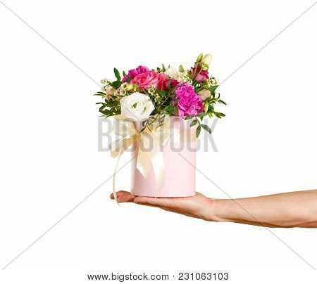 Composition Of Flowers In A Pink Hatbox. Tied With Wide White Ribbon And Bow.