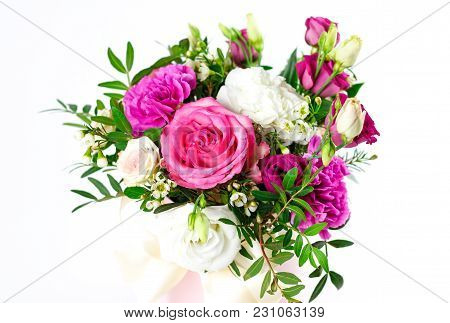Composition Of Flowers In A Pink Hatbox. Tied With Wide White Ribbon And Bow.