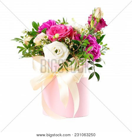 Composition Of Flowers In A Pink Hatbox. Tied With Wide White Ribbon And Bow.