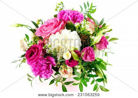 Composition Of Flowers In A Pink Hatbox. Tied With Wide White Ribbon And Bow.