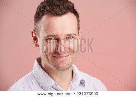 Headshot Of Smling Young Man Isolated On Pink Background