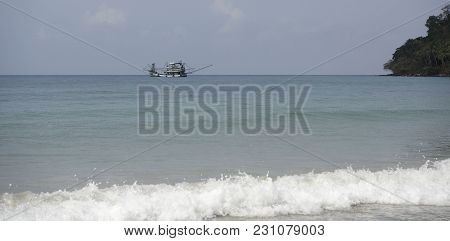 Ko Kut,thailand- February 26,2018: Fishing Boat Sail Near The Beach Of The Paradise Coconut Island
