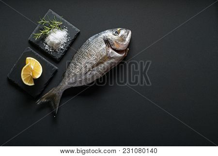 Delicious Fresh Gilt-head Fish On Dark Vintage Background. Healthy Food Diet Or Cooking Concept