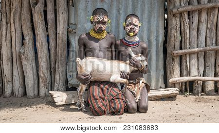 Omo Valley, Ethiopia, September 2017: Portrait Of Unidentified Karo Tribe Children Holding A Goat, C