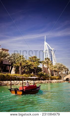DUBAI, UAE - FEBRUARY, 2018: View on Burj Al Arab, the world only seven stars hotel seen from Madinat Jumeirah, a luxury resort which include hotels and souk spreding across over 40 hectars.