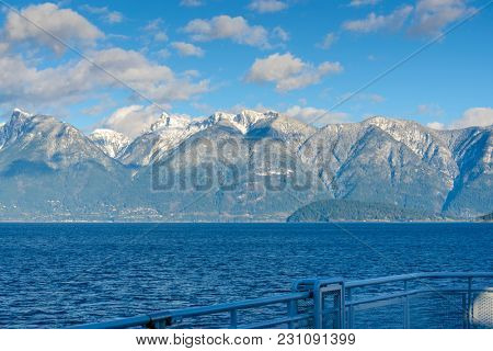 Fantastic view over ocean, snow mountain and rocks at Sechelt inlet in Vancouver, Canada.