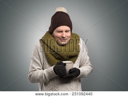 Handsome young boy freezing in warm clothing with copy space
