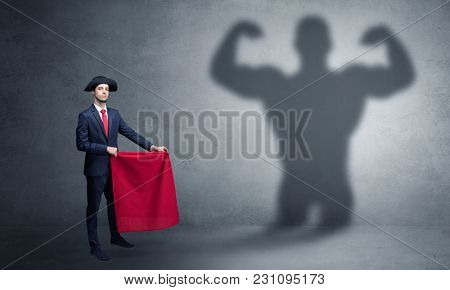 Businessman standing with red cloth on his hand and strong hero shadow on the background