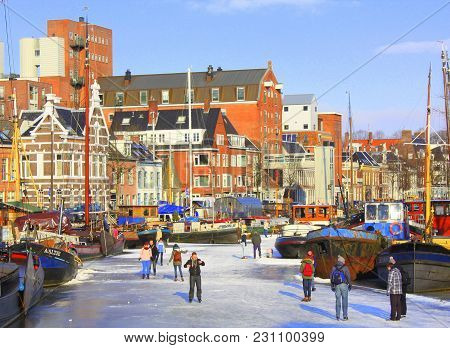 Groningen.february-10-2012. Skating In The Harbor Noorderhaven And On The Background Historic Houses