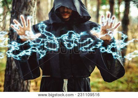 The Black Monk Pointing His Finger In The Woods