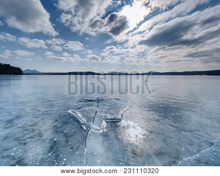 Big Piece Of Ice With Abstract Cracks Inside. Icicle Block Indetail With Frozen Bubbles And Rich Str