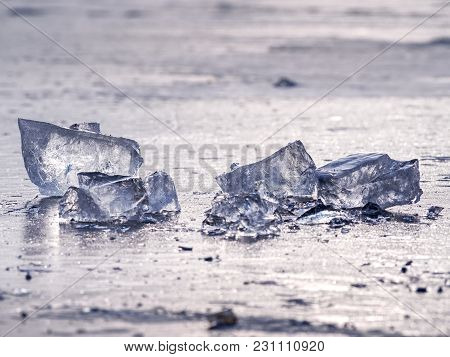Shining Shards Of Broken Ice. Abstract Still Life Of Ice Floes On Lavel Of Frozen Lake.