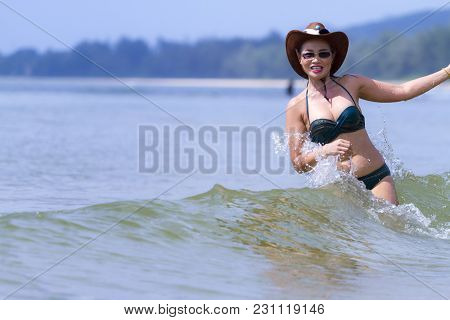 Woman And Bikini Beautiful Play Wave On Beach At Bang Beot Beach, Chumphon Province Thailand