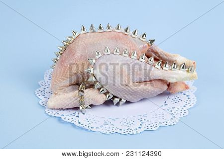 Playful Mashup Using A Chicken And Punk Spikes On A Blue Background. Minimal Color Still Life And Qu