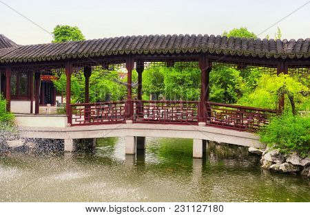 A Water Fountain And Covered Corridor At The Classical Chinese Li Yuan Garden In Zhaojialou In Shang