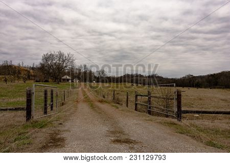 Dirt Lane Leading To A Traditional Beef Cattle Farm In Rural Appalachia Under Overcast Skies In Janu