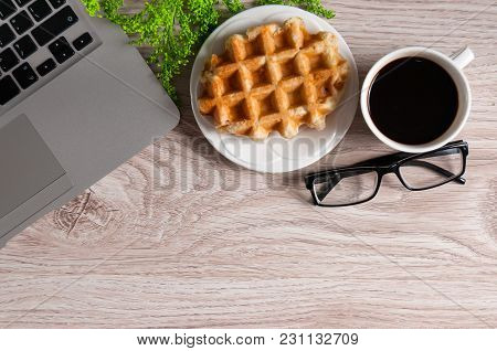 Notebook With Hot Coffee With Wafer On Wood Table