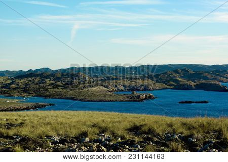 View From Cap De Cavalleria To Torre And Port De Sanitja On Blue Sky Background. Minorca, Balearic I