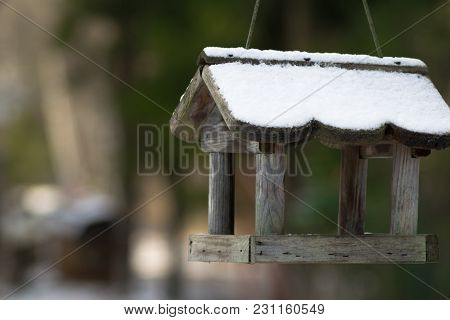 Bird House In Winter Covered With Snow