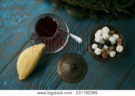 Traditional Azerbaijan Sweet Pastry Shekerbura With Nuts And Honey And Glass Of Black Tea On Wooden 