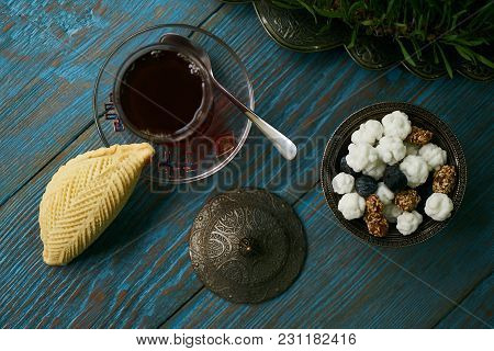 Traditional Azerbaijan Sweet Pastry Shekerbura With Nuts And Honey And Glass Of Black Tea On Wooden 
