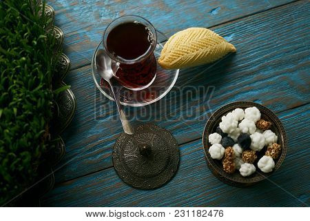 Traditional Azerbaijan Sweet Pastry Shekerbura With Nuts And Honey And Glass Of Black Tea On Wooden 