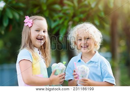Kids Eating Ice Cream. Child With Fruit Dessert.