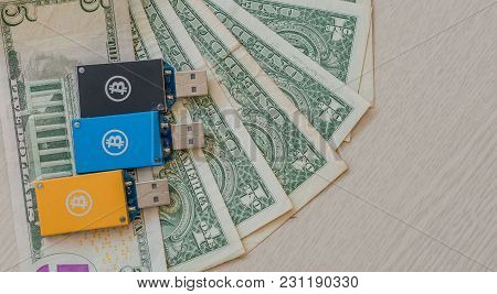 Gold, Blue And Black Thumb Drive Usb Bitcoin Miners On Top Of Stack Of American Money